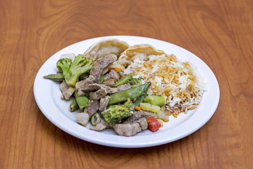 Plate with rice, dumplings, beef and broccoli